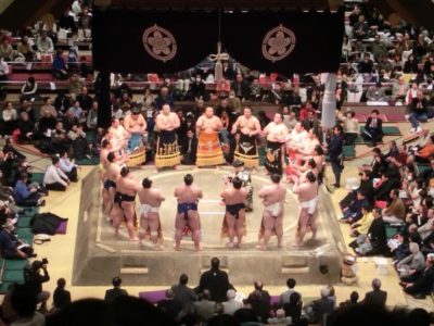 Sumo wrestlers standing in a circle in the ring in Ryogoku, Tokyo, Japan. A great addition to a travel itinerary.