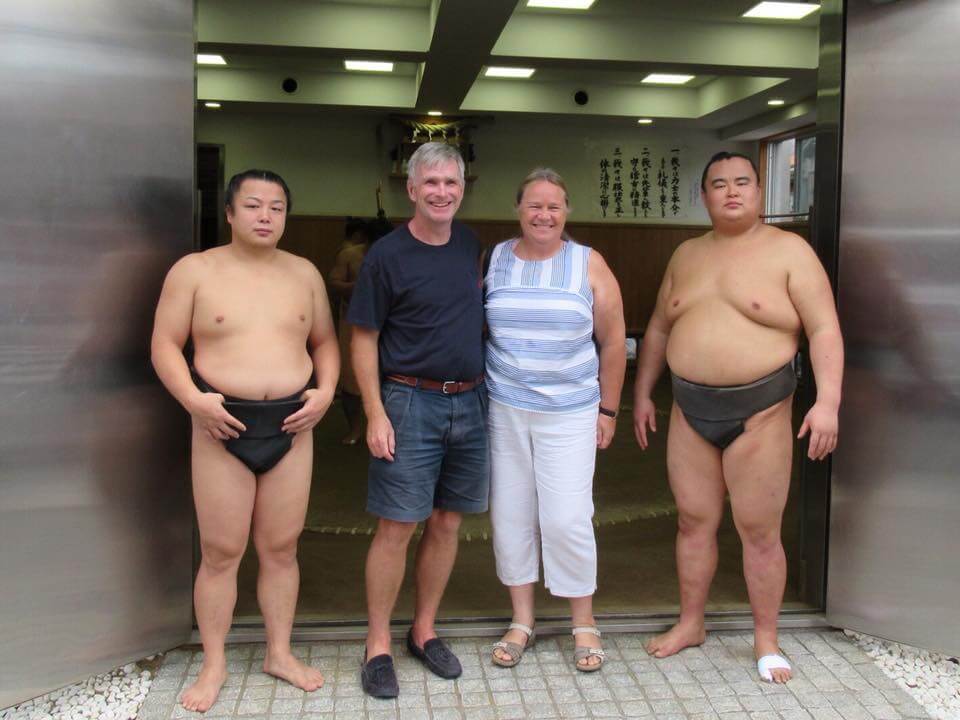 Sumo wrestlers posing with a tourist in Ryogoku, Tokyo, Japan