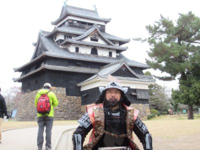 Matsue Castle with a man dressed as a samurai in front, Shimane, Japan