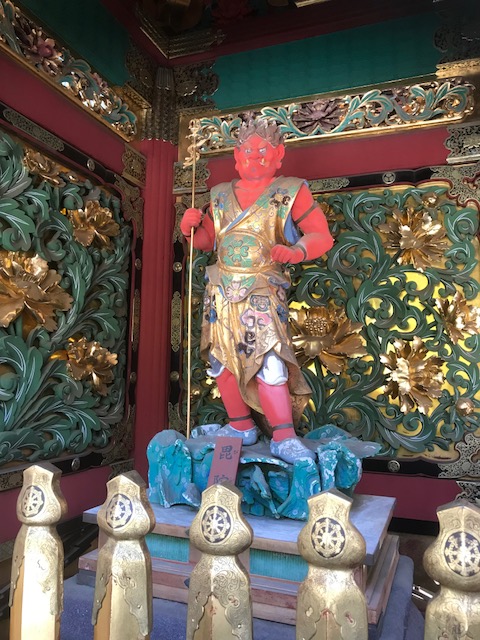 Red statue at the gate of the Taiyuin temple in Nikko, Japan