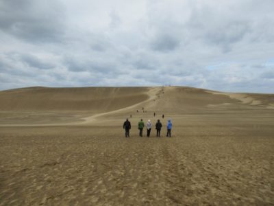 Tourists walking in the Tottori Sand Dunes in Japan