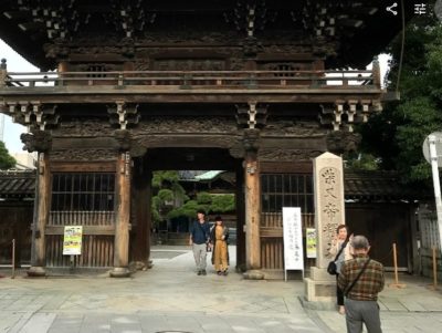 Japanese tourists taking pictures in front of Shibamata temple