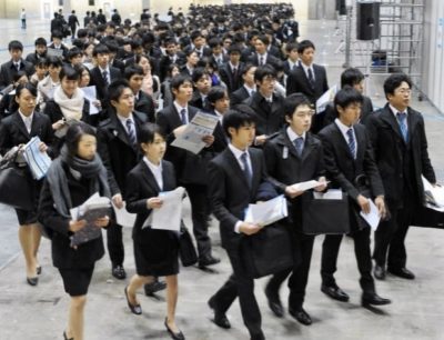 Dozens of young Japanese job seekers wearing suits
