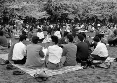 Office company workers sitting in a park in Japan