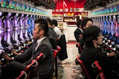 Men in suit playing pachinko. Pachinko is one of the legal forms of gambling in Japan