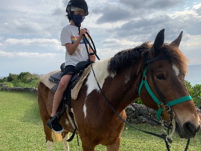Boy riding a horse in Okinawa, Japan